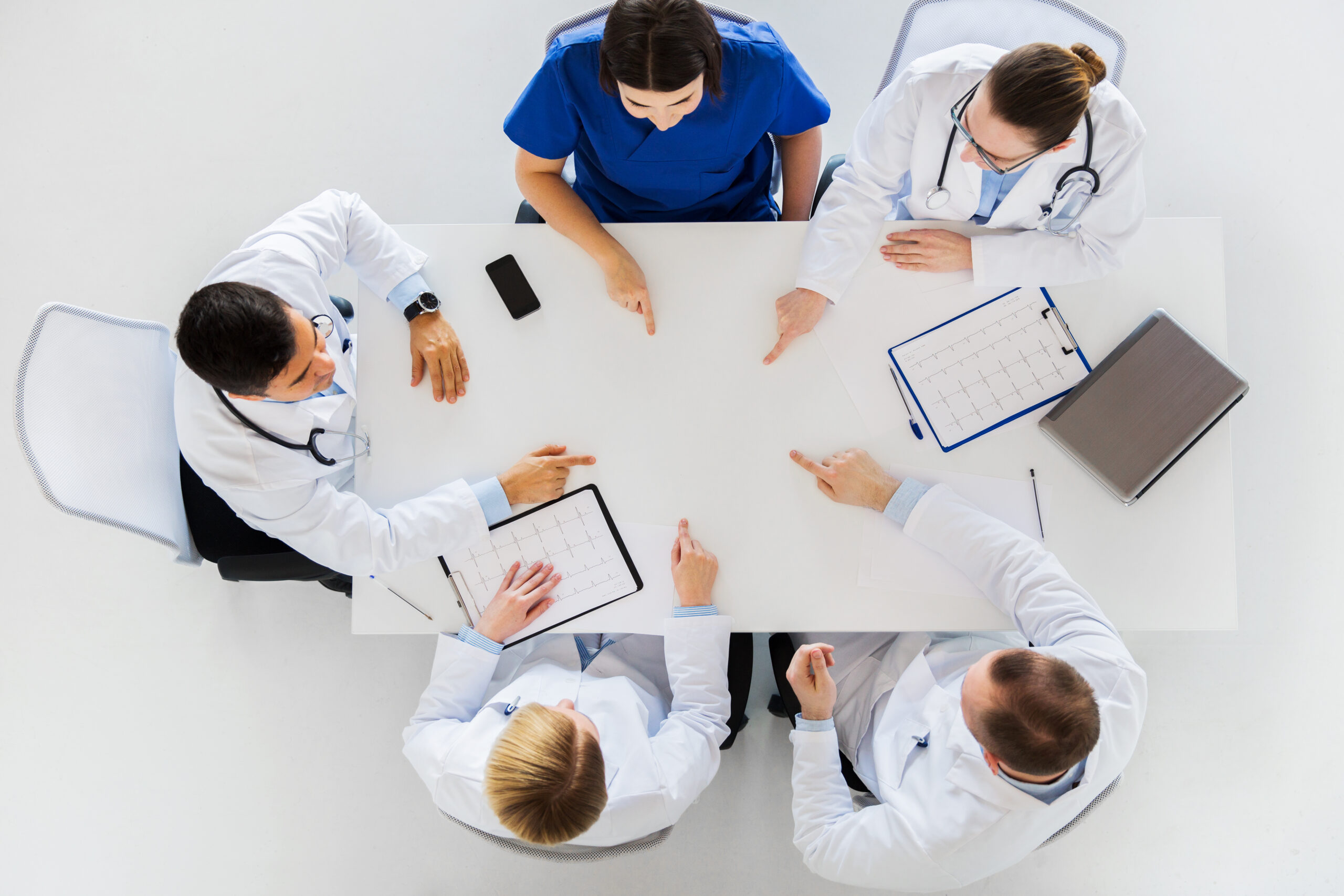group of doctors with cardiograms working at table