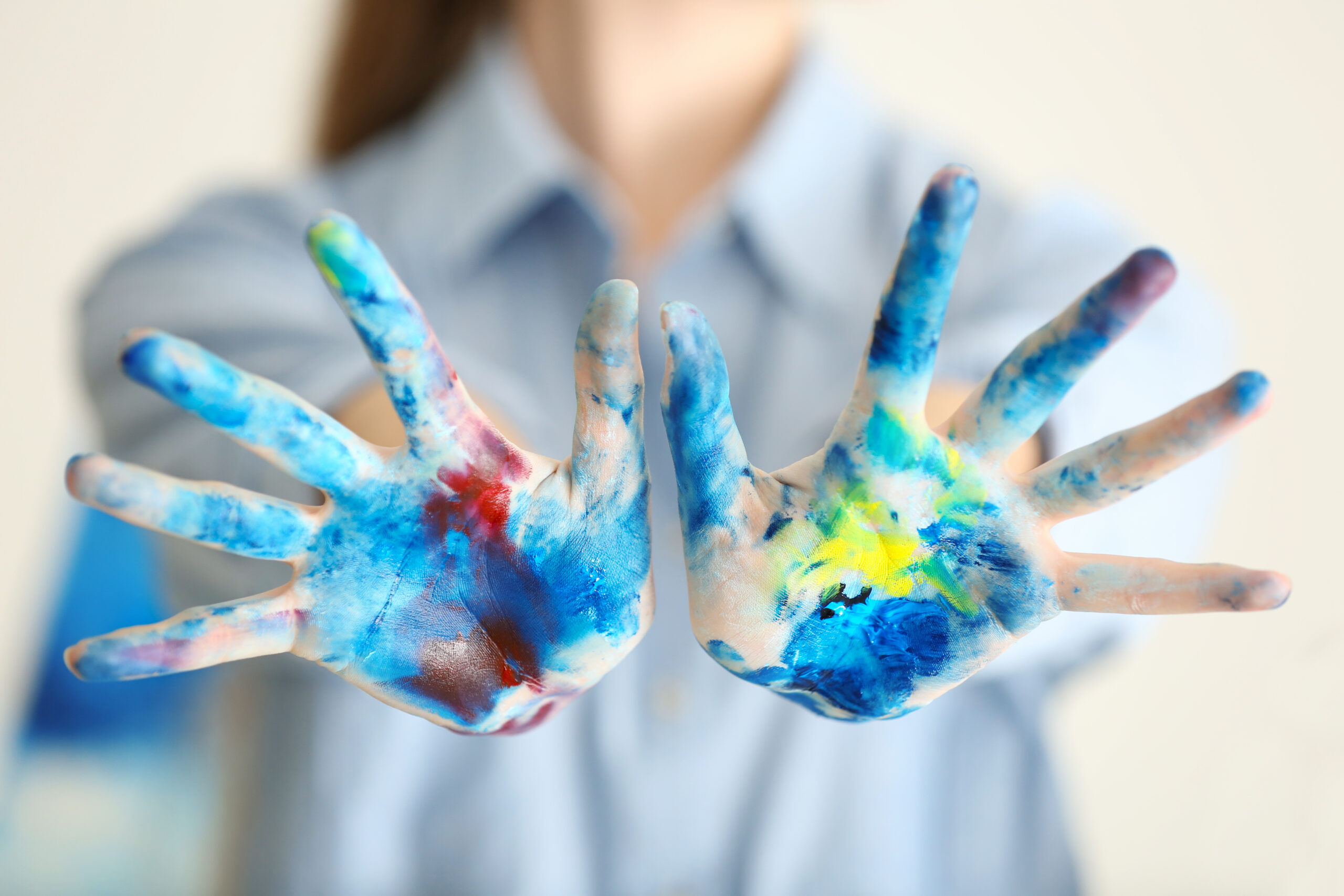 Female artist's hands in paint, closeup
